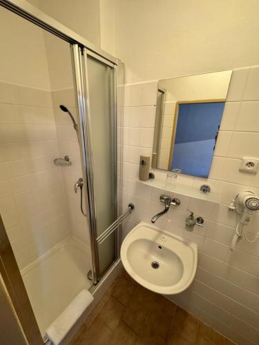 a bathroom with a shower and a toilet and a sink at Penzion Janoštík in Rožnov pod Radhoštěm