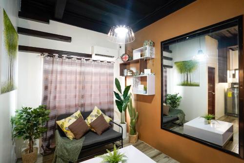 a living room with a mirror and a couch at JMO Apartments in Antipolo