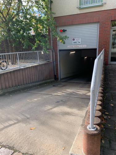 a parking garage with a garage door and a building at Neu Studio Leipzig Zentrum in Leipzig