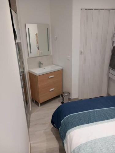 - une chambre avec un lit, un lavabo et un miroir dans l'établissement Studio plain-pied 2 Personnes 150 m de la plage, au Crotoy