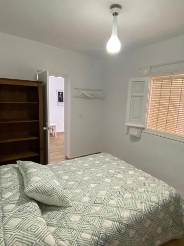 a bedroom with a bed and a window at Alojamiento Rural VivoBosque in El Bosque