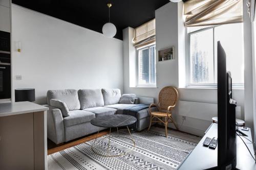 a living room with a couch and a table at Luxury 1 Bed Apartment Covent Garden Holborn in London