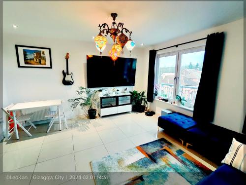 a living room with a flat screen tv and a couch at La Casita, Your Home Away from Home - Free Parking in Glasgow
