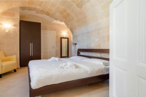 a bedroom with a bed with towels on it at Terrazze San Martino in Matera