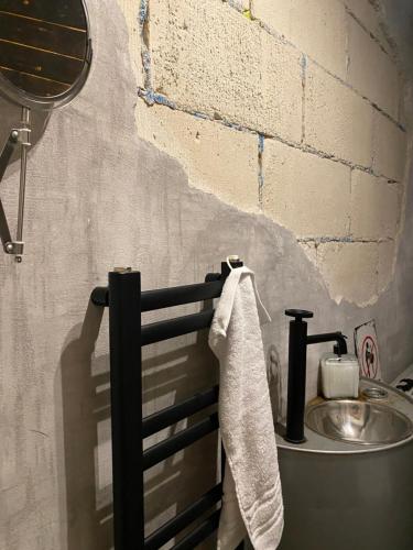 a bathroom with a sink and a towel on a rail at Apartament maciejoki in Wejherowo