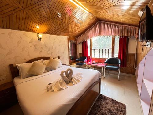 Una cama o camas en una habitación de Hotel Navrattan