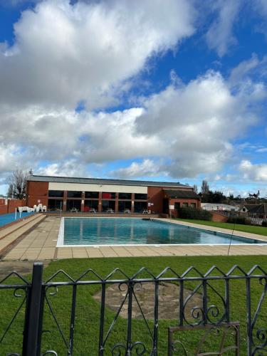 a swimming pool in front of a building at Holiday Caravan in Clacton-on-Sea