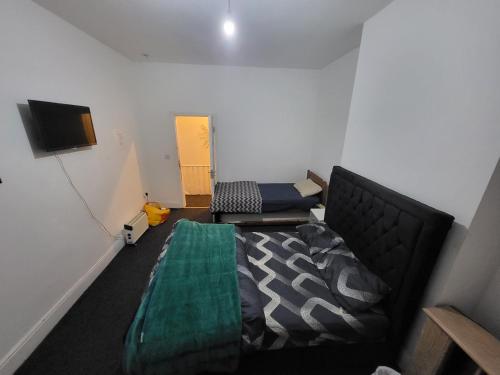 a room with a bed and a couch and a tv at Adam letting(s) in Middlesbrough