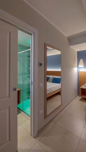 a mirror in a room with a bedroom at MaLù BEST Rooms - Tropea in Tropea