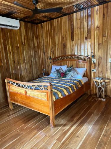 a bedroom with a wooden bed in a room at Tropical Magnolia 