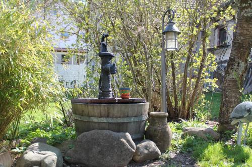 a fountain in a garden with a street light at FeWo Alte Post in Oberdigisheim