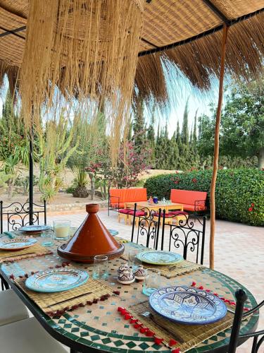 a table with plates of food on a patio at RIAD YANITRI Piscine chauffée in Essaouira