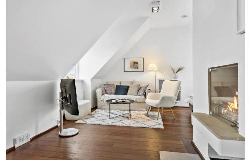 a living room with a couch and a tv at Gorgeous Apartment In Skagen With Sauna in Skagen