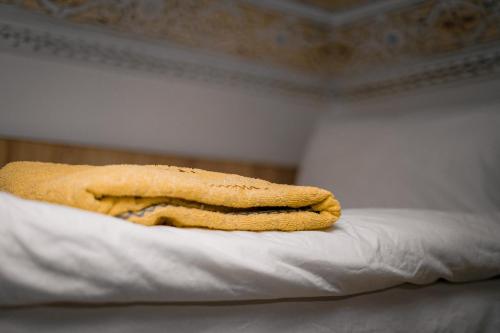 two towels are sitting on top of a bed at Soul Surf House Anza in Agadir