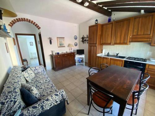 a living room with a couch and a table at A window to the sea in Riva Trigoso