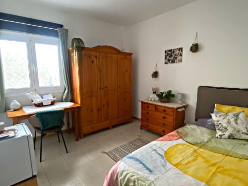 Schlafzimmer mit einem Bett, einem Schreibtisch und einer Kommode in der Unterkunft Amanecer Isleño Habitaciones in Arrecife