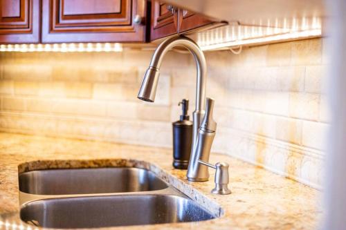 a kitchen sink with a faucet on a counter at High-End Oasis Close to Fun in Homewood