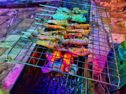 a bunch of food cooking on a grill at Charming Pool Twin Holiday Home in Patong Beach