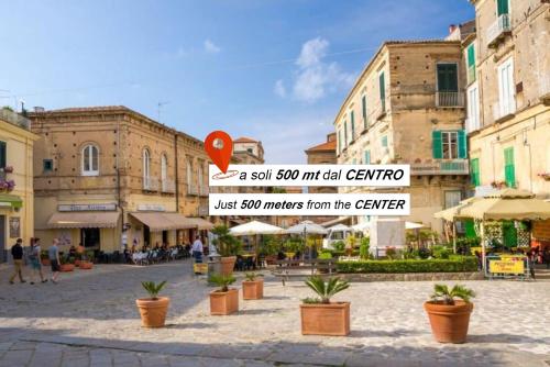 a street sign in a city with potted plants at Don Francisco Rooms - TROPEA in Tropea