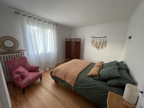 a bedroom with a bed and a chair at Le Coty - Appartement -St Marie des champs in Sainte-Marie-des-Champs