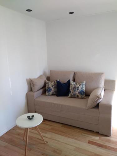 a living room with a couch and a table at Complejo Del Este Suites in San Carlos de Bariloche