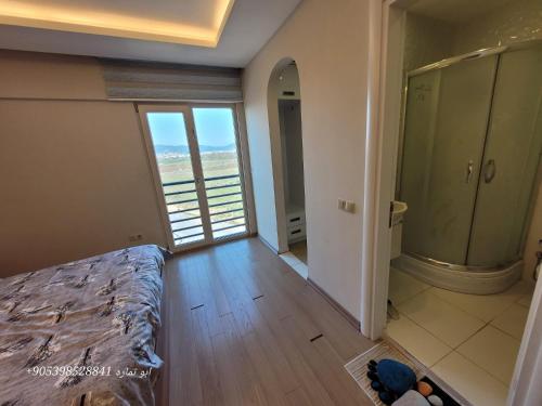 a bedroom with a bed and a balcony with a view at تركيا . بورصا . منتجع بورصا مودرن in Bursa