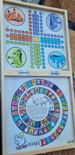 a board game with different animals on it at La Dragonne, centre de Bellême, maison entièrement équipée, jardin, vue forêt in Bellême