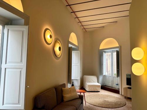 a living room with a couch and a room with arches at Civita Boutique in Catania