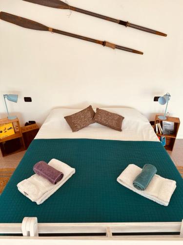 a bedroom with a bed with two towels on it at THERANCOBAY - lake view apartment - in Ranco