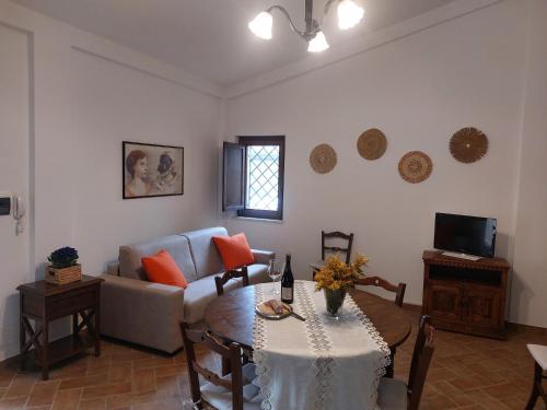 a living room with a table and a couch at La Selvarella in Montecchio
