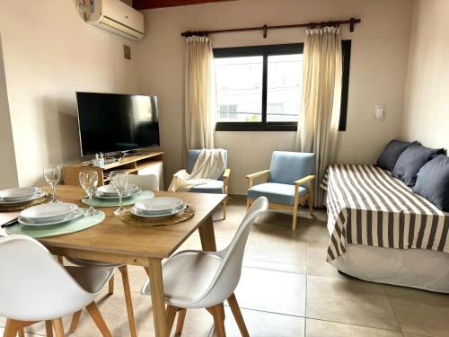 a living room with a table and a couch at Departamento en complejo semiprivado con cochera in Guaymallen