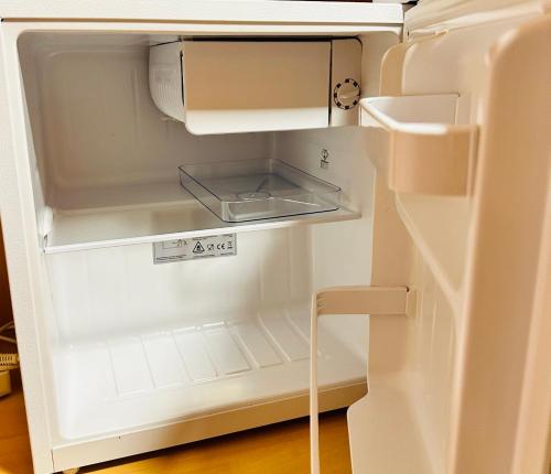 an empty refrigerator with its door open with the door open at Double Room with bathroom in Alicante