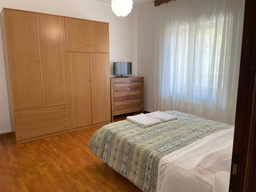 a bedroom with a bed with a dresser and a cabinet at Bellavista (grande) in Barete