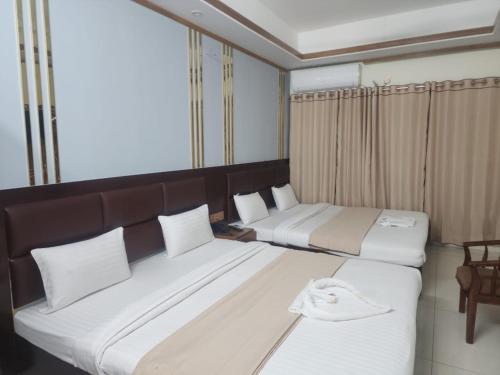 Ένα ή περισσότερα κρεβάτια σε δωμάτιο στο Hotel S.A International