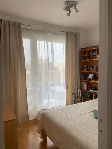 a bedroom with a bed and a large window at Apartment Linkerover- City Centre & Cathedral view in Antwerp