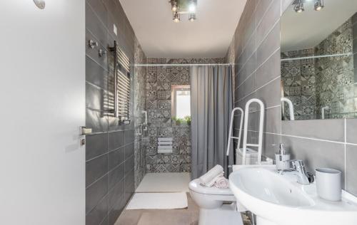a bathroom with a sink and a toilet and a shower at Villa La Ola in Benissa