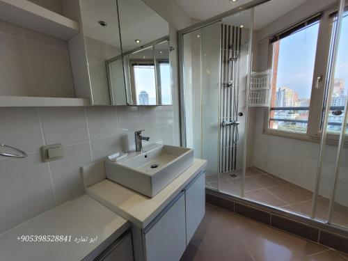 a white bathroom with a sink and a shower at Apartment in Bursa - Turkey in Bursa
