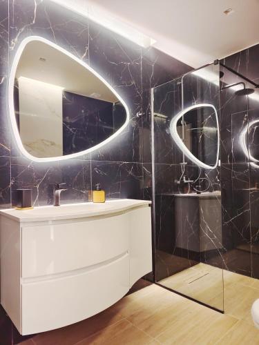 a bathroom with a sink and a mirror at Volos Guesthouse Chrysa in Volos