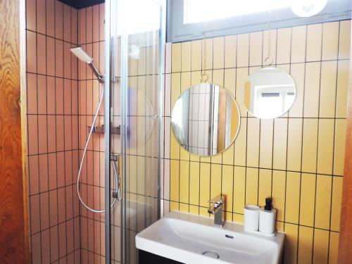 a bathroom with a sink and a shower with a mirror at Strasbourg Evasion Pop in Strasbourg