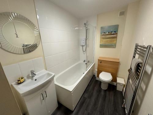 a bathroom with a sink and a toilet and a mirror at Castle Wynd Old Town in Edinburgh