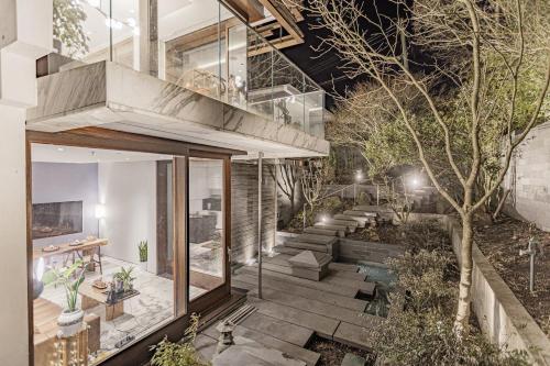 a house with a courtyard with a tree at S-Villa plus Water Feature & Zen Garden in Vancouver