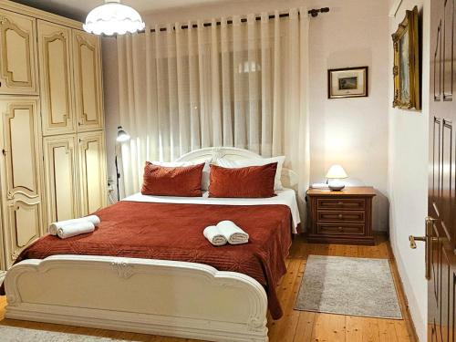 a bedroom with a bed with two towels on it at All Seasons Apartments - Free Parking & City Center in Shkodër