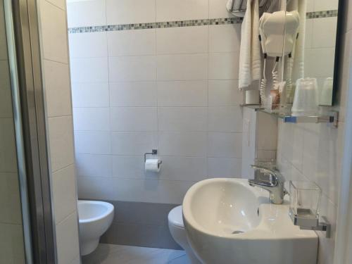 a bathroom with a sink and a toilet at Hotel Lido in Varazze