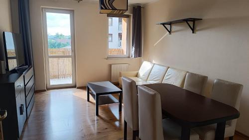 a living room with a couch and a table at Apartament Radzikowskiego in Krakow