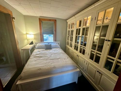 a small bedroom with a large bed in it at Welcome to the Lake in Northwood