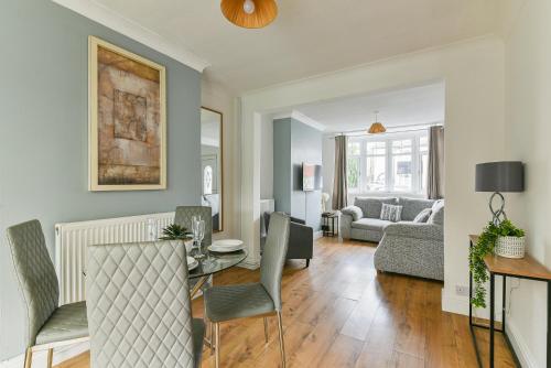 a living room with a table and chairs at Fabulous 3 Bedroom House Near Black Country Museum Contractors & families in Tipton