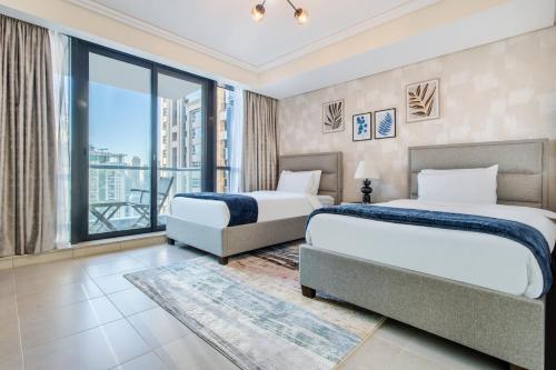 two beds in a hotel room with a view at 3 Bedroom Luxurious Lake View Apartment in Dubai