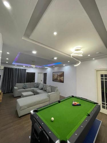 a living room with a pool table and a couch at Predam Realty in Lagos