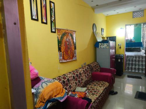 a living room with a couch in a room at JHARANA GUEST HOUSE in Puri