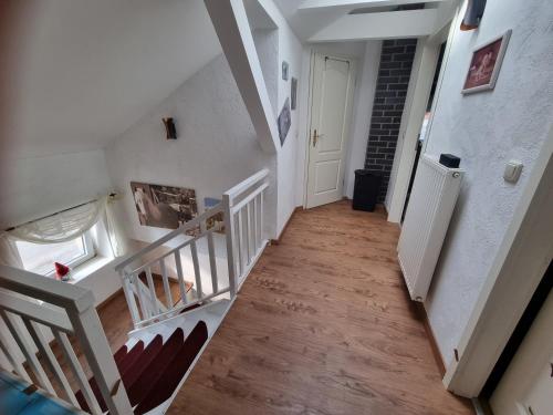 a hallway with stairs leading to a white door at Landhaus Bia in Burig